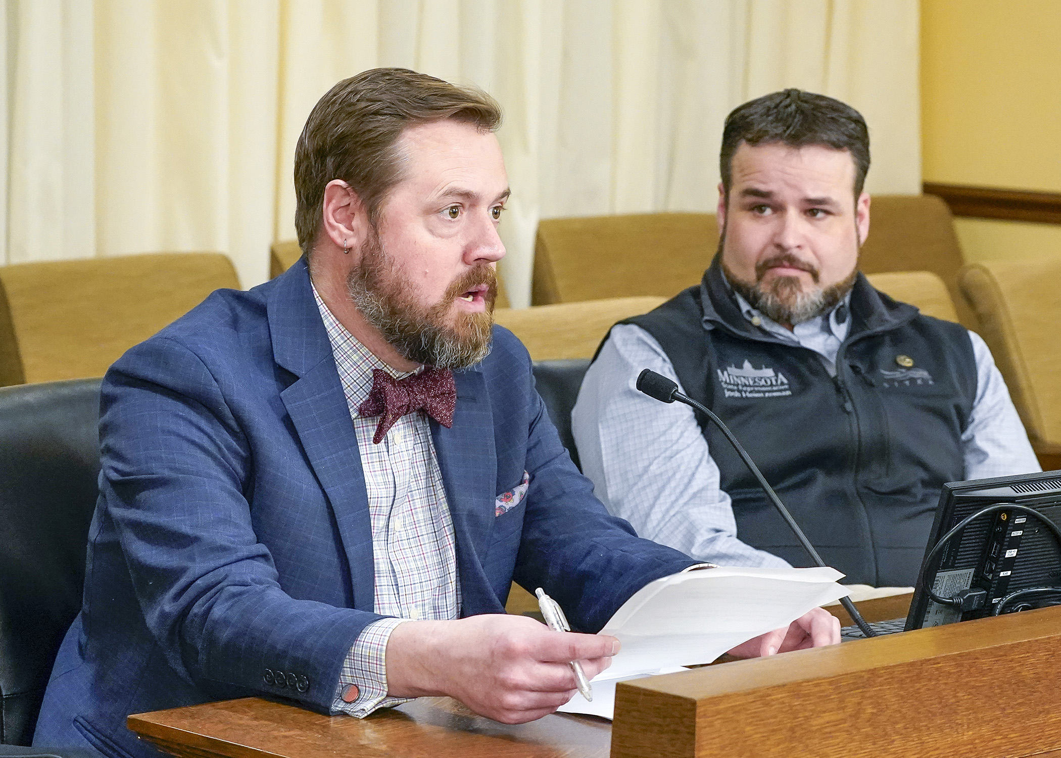 Representing the Recreational Off-Highway Vehicle Association, Kyle Makarios testifies March 4 in support of a bill sponsored by Rep. Josh Heintzeman, right, that would exempt certain juvenile products from PFAS prohibitions. (Photo by Andrew VonBank)